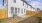 a house with a fence and a dirt yard