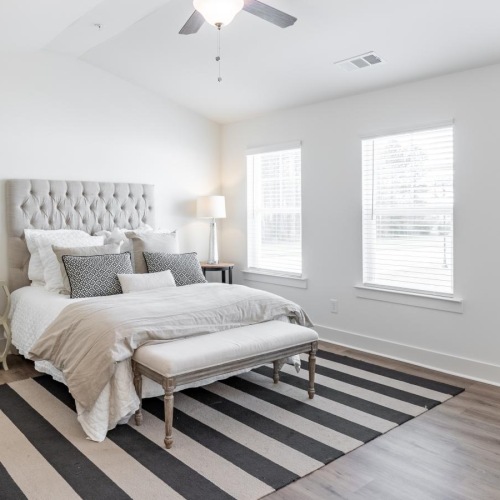 a bedroom with a bed and a fan