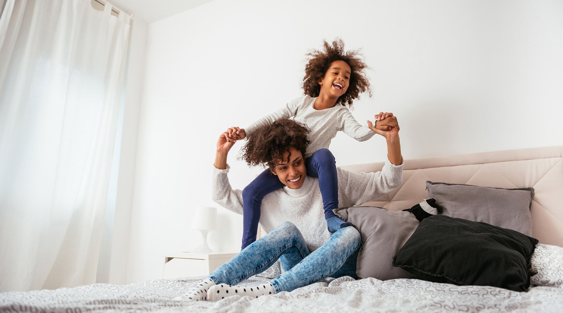 mother and daughter on bed