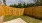 a wooden fence in back of a house